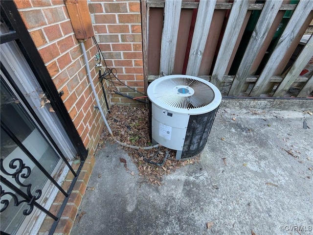 exterior details with brick siding and central AC