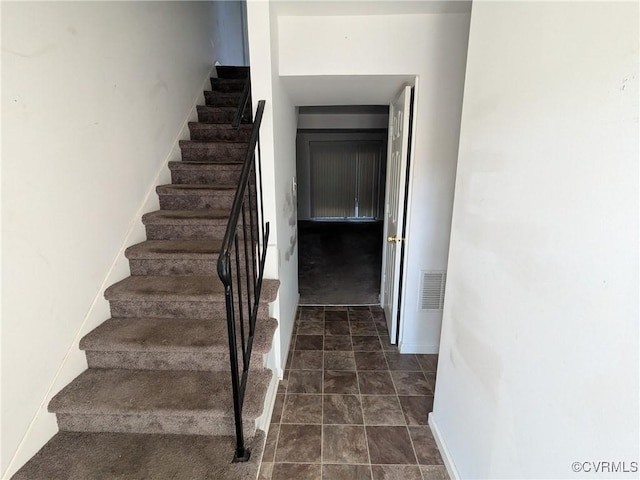 stairs with visible vents and baseboards