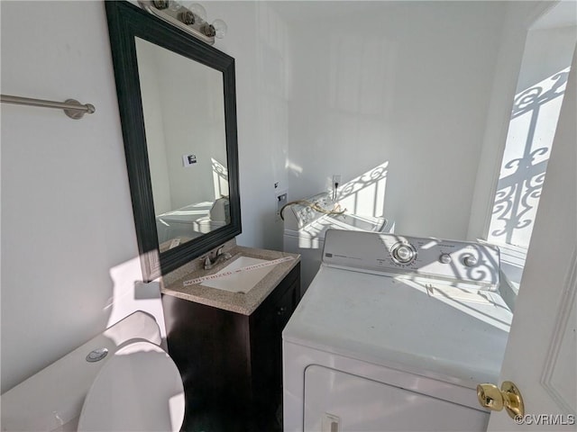 laundry room with laundry area, washer and dryer, and a sink