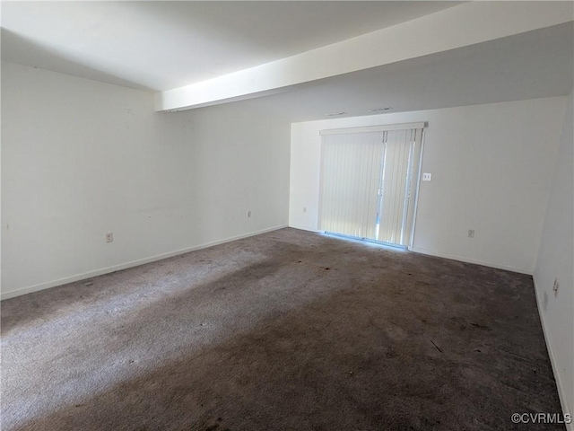 carpeted empty room featuring baseboards