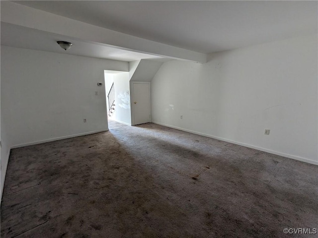 additional living space featuring baseboards and carpet floors