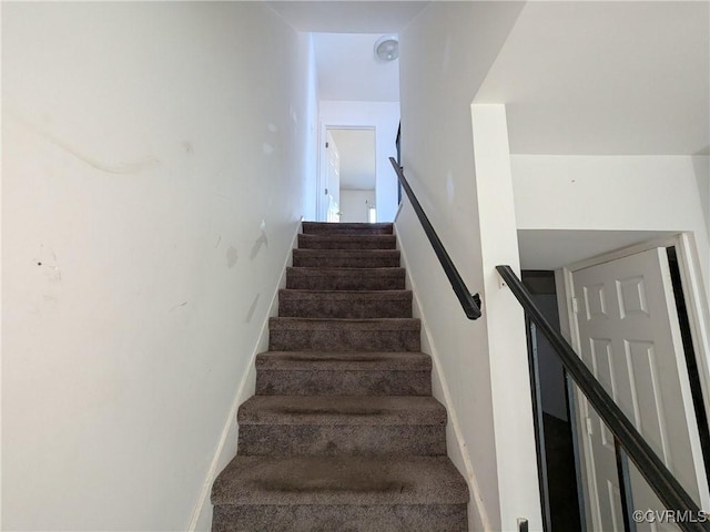 stairway featuring baseboards