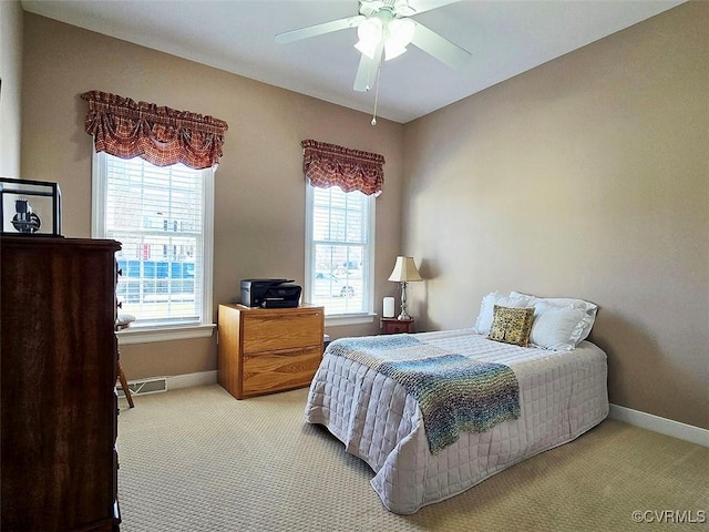 bedroom with visible vents, carpet flooring, a ceiling fan, and baseboards