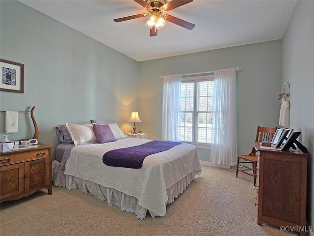 bedroom featuring light colored carpet and a ceiling fan