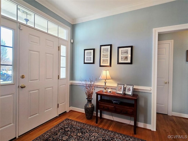 foyer entrance with a wealth of natural light, ornamental molding, and wood finished floors