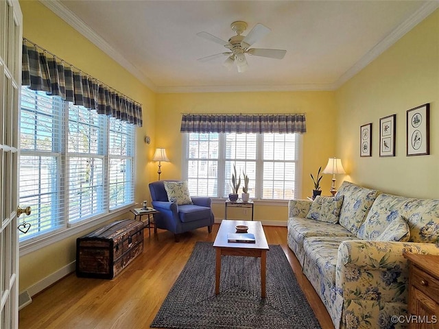 living area featuring light wood-type flooring, plenty of natural light, and ornamental molding