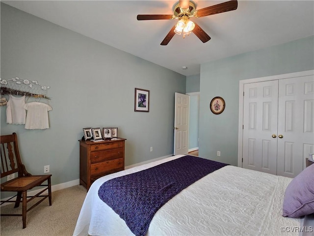 carpeted bedroom featuring a closet, ceiling fan, and baseboards