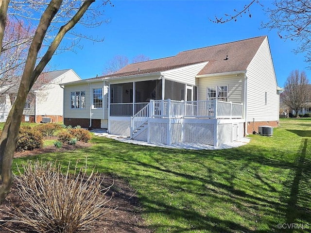 rear view of property featuring a lawn, stairway, cooling unit, a sunroom, and crawl space