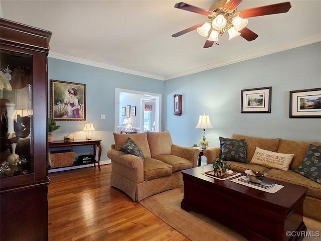 living room featuring a ceiling fan, wood finished floors, and ornamental molding