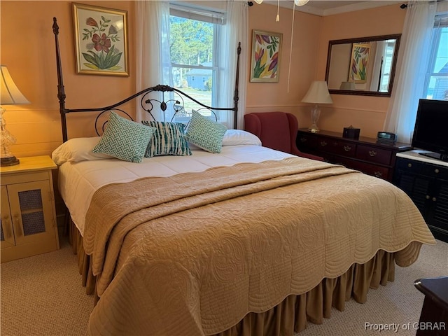 bedroom with light carpet and crown molding