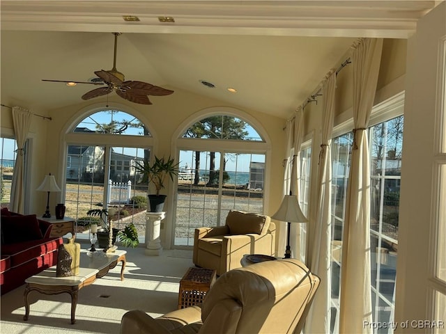 sunroom / solarium with a wealth of natural light, visible vents, lofted ceiling, and a ceiling fan