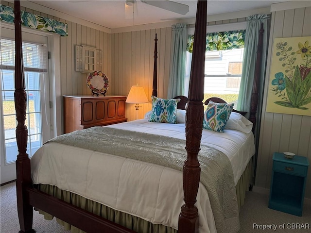 carpeted bedroom with wood walls