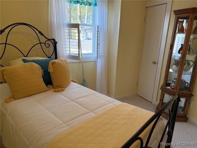 carpeted bedroom featuring baseboards