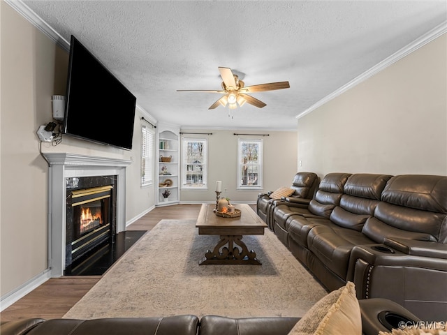 living area with plenty of natural light, a textured ceiling, and wood finished floors