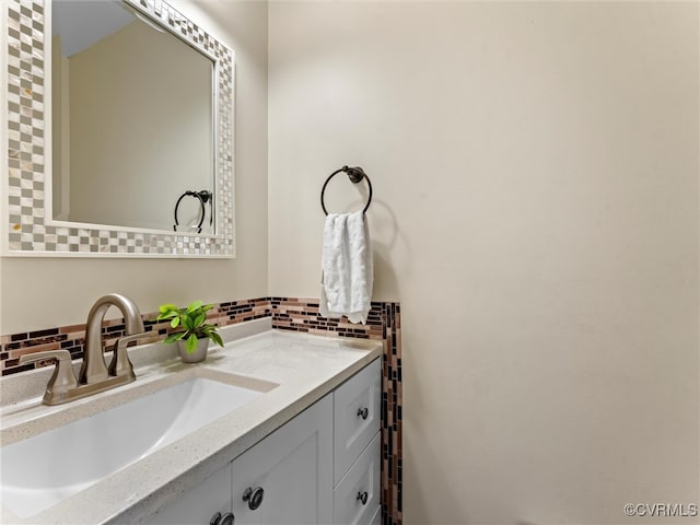 bathroom featuring decorative backsplash and vanity