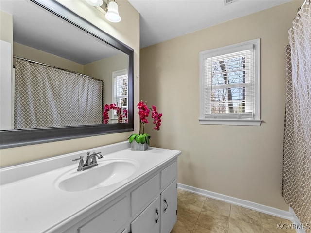 full bathroom featuring baseboards and vanity