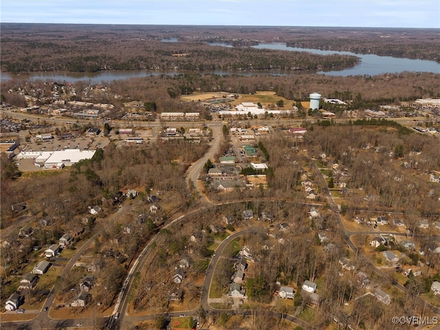 aerial view with a wooded view and a water view