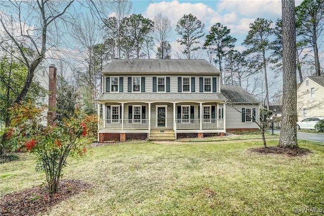 colonial house with a porch and a front yard