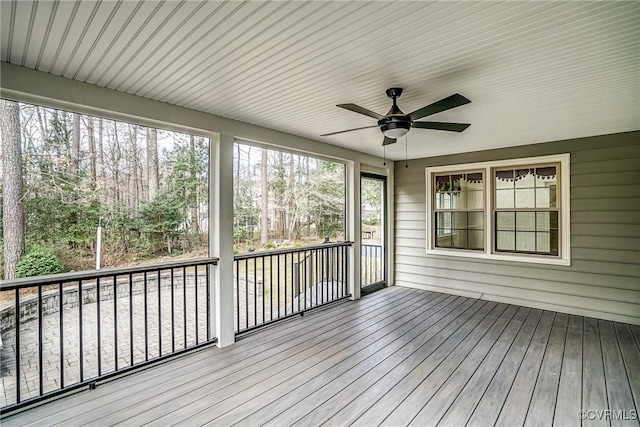 unfurnished sunroom with a ceiling fan