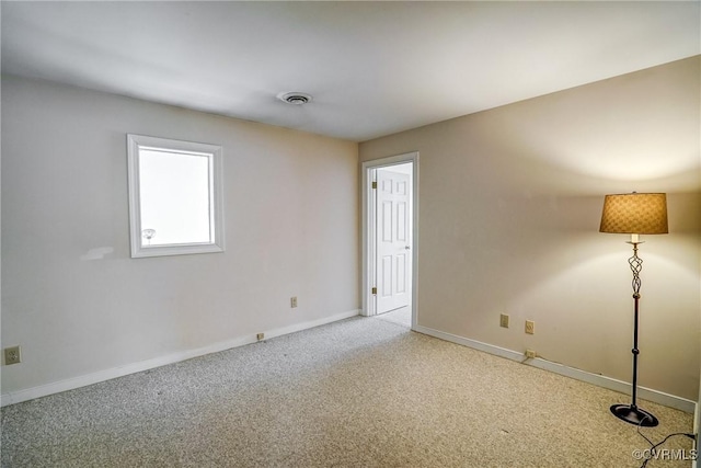 spare room featuring baseboards and carpet floors