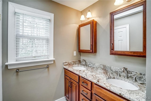 full bath with double vanity and a sink