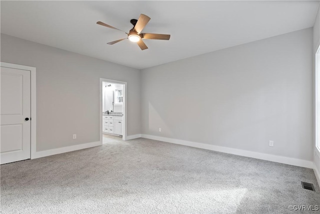 empty room with visible vents, baseboards, and light colored carpet