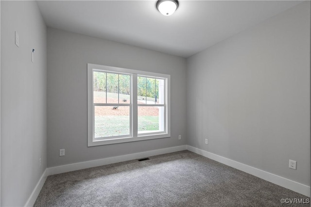 unfurnished room featuring visible vents, baseboards, and carpet