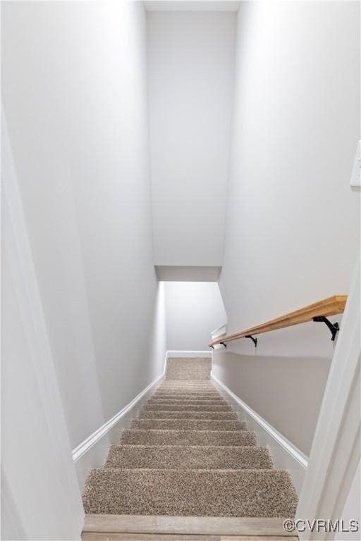 stairway with carpet and baseboards