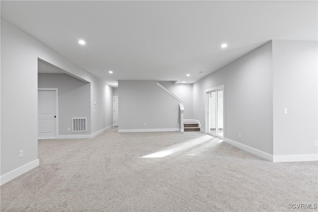 below grade area with visible vents, recessed lighting, stairway, and baseboards