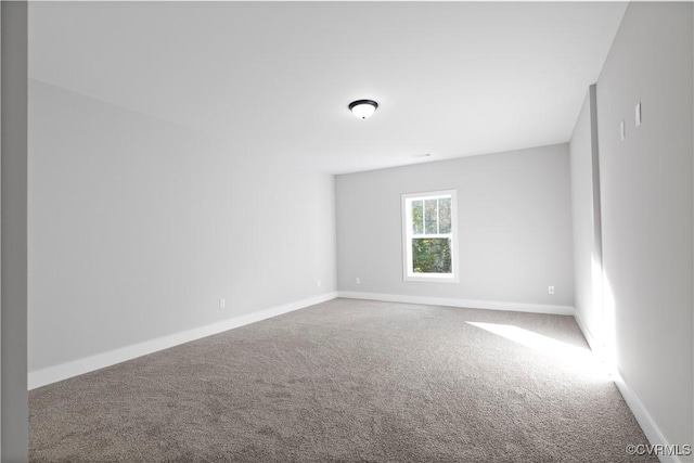 empty room with carpet and baseboards