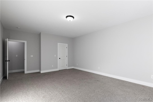 unfurnished bedroom featuring carpet flooring and baseboards