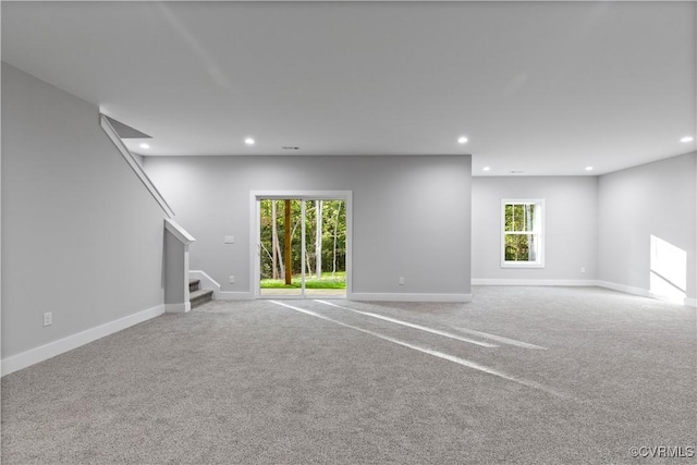 unfurnished living room featuring stairway, carpet flooring, recessed lighting, and baseboards