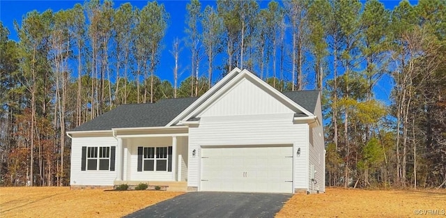 view of front facade featuring aphalt driveway and an attached garage