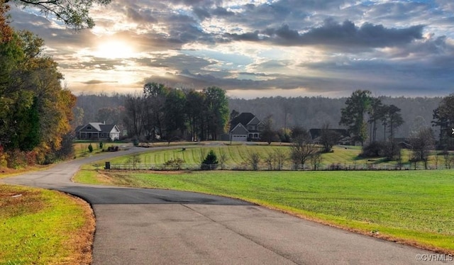 view of street featuring a rural view and a wooded view