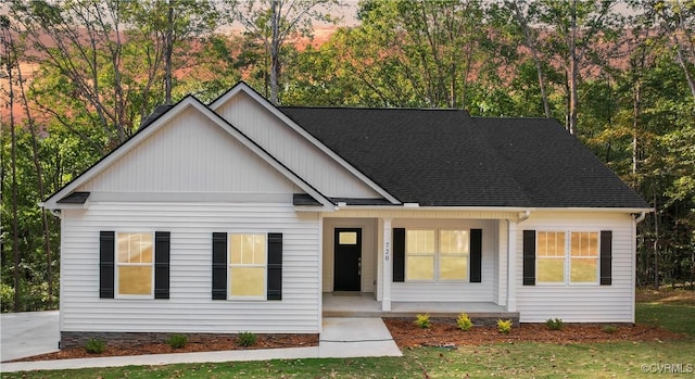 view of front of property with a porch and roof with shingles