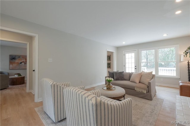 living area with recessed lighting, baseboards, and light wood-style floors