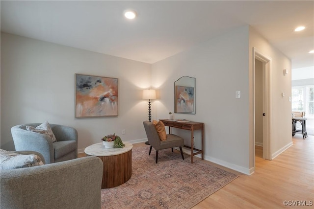 sitting room featuring light wood-style flooring, recessed lighting, and baseboards