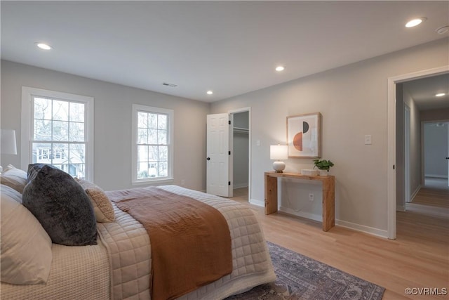 bedroom with recessed lighting, visible vents, baseboards, and light wood finished floors