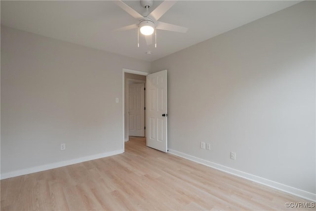 empty room with baseboards, light wood-style floors, and ceiling fan