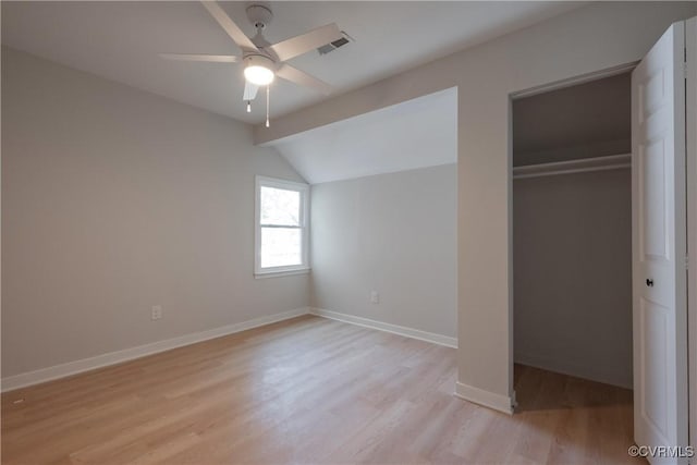 unfurnished bedroom featuring a ceiling fan, baseboards, visible vents, light wood-style floors, and a closet