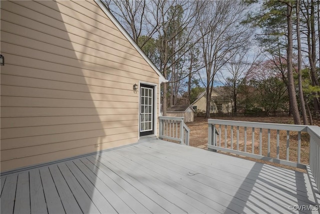 wooden deck with an outdoor structure and a shed