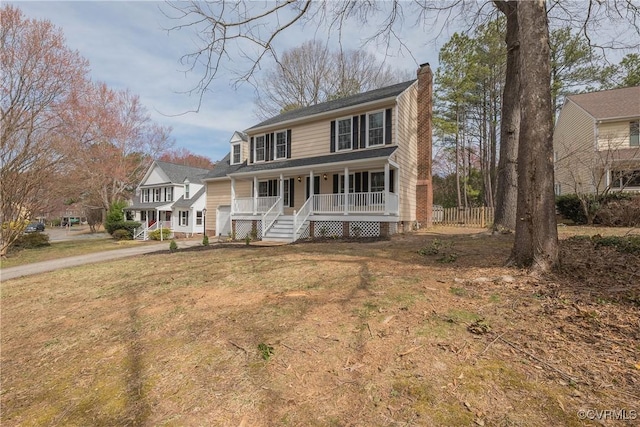 view of front facade with a front lawn, covered porch, driveway, and a chimney