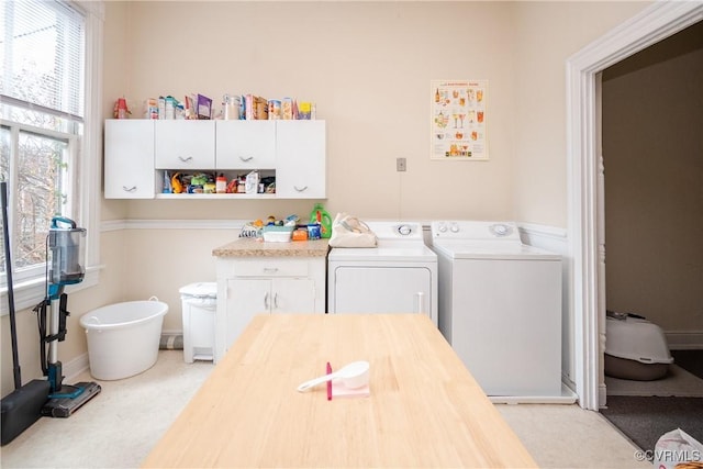 washroom with washer and dryer, cabinet space, and carpet floors