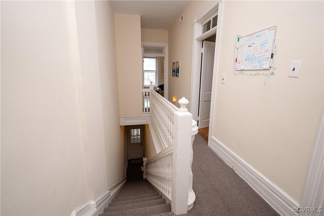 stairway with carpet and baseboards