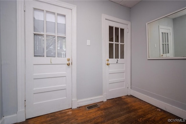 entryway with visible vents, baseboards, and dark wood finished floors