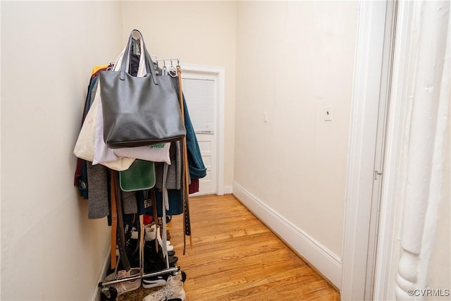 hallway with baseboards and light wood finished floors