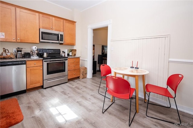 kitchen featuring light wood finished floors and stainless steel appliances