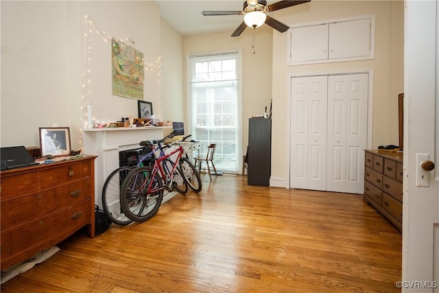 misc room with a ceiling fan and light wood finished floors