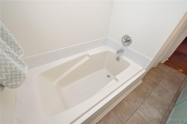 full bath with tile patterned flooring and a garden tub