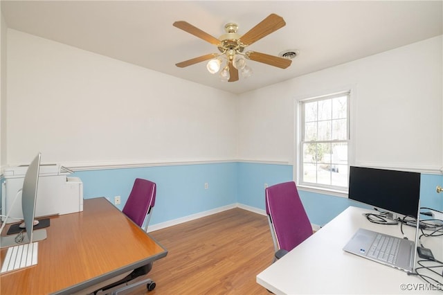 office area with ceiling fan, visible vents, baseboards, and wood finished floors